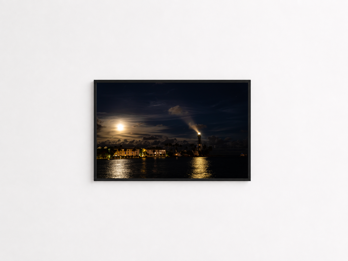 Moonlit lighthouse coastal photography print in a black frame