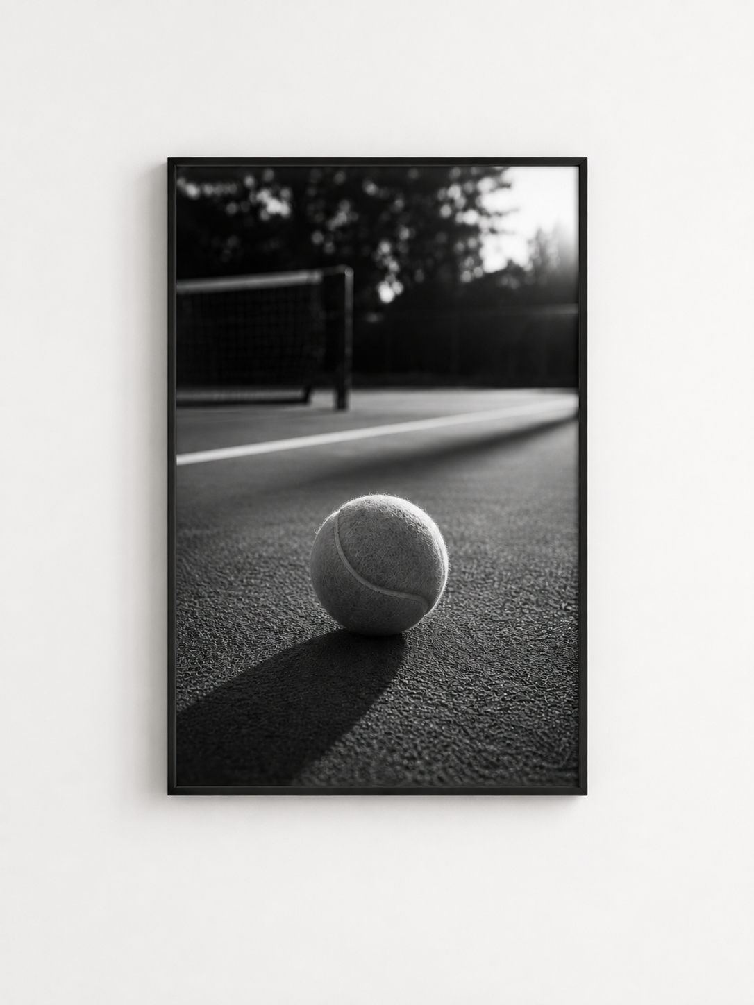 Black and white tennis ball photography print in a black frame