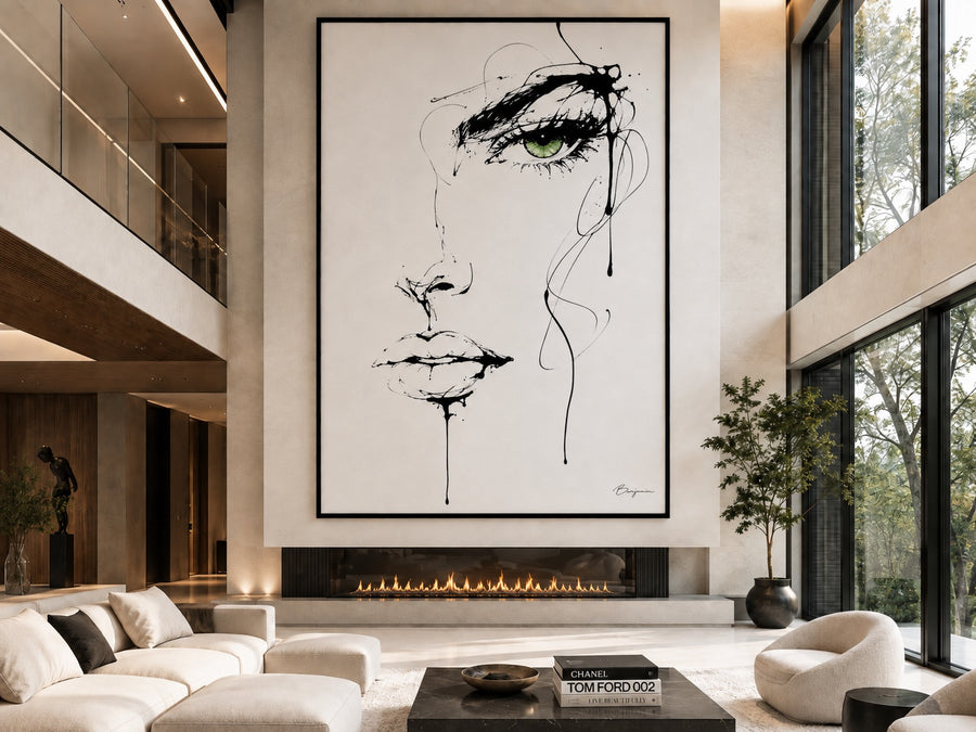 Inked oversized framed portrait artwork displayed above a modern glass fireplace